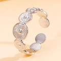 Vintage silver sunburst engraved open ring in brushed stainless steel on orange backdrop - Silver