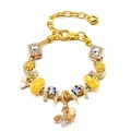 Golden charm bracelet with bee, butterfly, and flower pendants on white background - Golden Bee & Butterfly Style (Model 009)