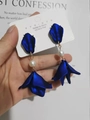 Close-up of layered navy blue petal earrings with white pearls and 925 silver needles - Sapphire Blue