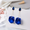 Detailed view of long petal drop earrings featuring matte Klein blue finish on white silk - Sapphire Blue