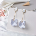 Detail of white matte petal drop earrings with gold rod accents and silk decoration - White