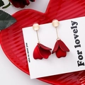 Close-up of red petal earrings with gold metallic accents on a red ceramic dish - Red Series Style 7 (A764)