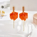 Macro detail of orange petal drop earrings with crystal beads and sparkling chain tassels - Orange Red
