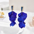 Detailed view of layered deep blue petal tassel earrings with gold trim on white satin - Sapphire Blue