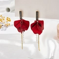 Detail of red petal earrings with matte finish, tassels, and sparkling crystal accents - Red With Black Top