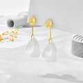 Detail of elegant gold drop earrings with tiered white matte flower petals - White Petal Style (A847)