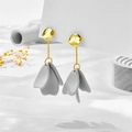 Macro detail of golden irregular stud earrings with grey petal-shaped resin pendants - Gray Petal Style (A848)