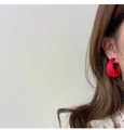 Close-up of a matte red C-shaped earring on model featuring a smooth frosted texture - Red (A317)