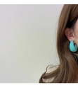 Close-up of a matte turquoise C-shaped hoop earring worn on model with a silver stud - Lake Blue (A324)