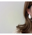 Close-up of matte white C-shaped hoop earrings and stud worn by a model in Korean style - White (A322)