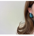 Close-up of matte blue geometric C-shaped earrings and crystal stud on model - Cyan Blue (A321)