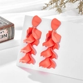 Detail of coral orange matte petal tassel earrings hanging on a white display card - Orange Red (A897)