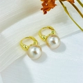 Detail view of pearlescent mermaid pearls on elegant gold hoop earrings on white fabric - White (A555)