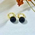 Detailed close-up of golden hoop earrings featuring elegant polished black pearl charms - Deep Black (A558)