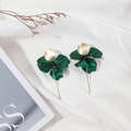 Close-up of matte dark green petal earrings with elegant gold accents on silk fabric - Holographic Green