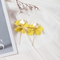 Macro shot of stylish long yellow floral petal earrings with golden matte metal accents - Yellow