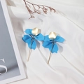 Detail of matte sky blue flower drop earrings with golden accents on white silk - Lake Blue
