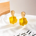 Detail of bright yellow layered petal earrings on a wooden stand with white silk cloth - Yellow Petal Style (A663)