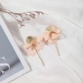 Elegant matte nude petal drop earrings with gold metal accents on white silk - Beige