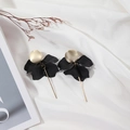 Fashionable gold disc and black matte petal dangle earrings on a soft white fabric - Black