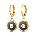 Macro detail of golden Evil Eye drop earrings featuring classic enamel round pendants - Black