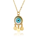 Detailed view of copper evil eye pendant with blue glass eye and hanging gold discs - Dark Blue