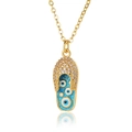 Macro shot of gold flip-flop pendant with blue enamel devil eyes and white zircons - Light Blue (D666-2)