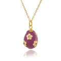 Macro detail of purple enamel egg pendant featuring white floral motifs and zircon crystal - Purple