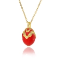 Macro shot of red enamel egg pendant with gold V-shaped zircon inlay on a delicate chain - Red