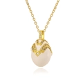 Detailed macro view of vintage egg-shaped enamel pendant with intricate gold filigree - White