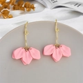 Detailed macro view of pink floral petal earrings with golden spiral hooks on a textured base - Pink (A1158)