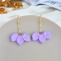 Close-up of matte purple petal earrings with wavy gold hooks on elegant display tray - Purple (A1157)
