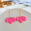 Macro detail of rose red petal earrings with gold textured hooks on a decorative plate - Magenta (A1155)