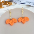 Macro detail of orange petal drop earrings with spiral gold hooks on a display tray - Orange (A1156)