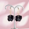 Detail of matte black multi-layered petal earrings with golden geometric hooks - Black Style (A1181)