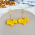 Detailed macro view of yellow layered petal earrings with gold hooks on a ceramic tray - Yellow (A1159)