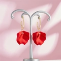 Detailed macro view of red petal earrings hanging on a metal display stand - Rose Red Style (A1170)