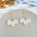 Detail of white flower petal earrings with golden hooks on luxury silk backdrop - Pearlescent White (A1163)