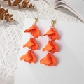 Macro detail of triple-layered orange petal earrings with golden heart studs - Orange (A1219)