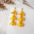 Close-up of bright yellow petal tassel earrings hanging on a white display card - Yellow (A1217)