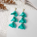 Detail of matte teal petal earrings with golden heart studs on white waffle fabric - Lake Blue (A1222)