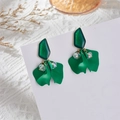 Close-up of matte green flower petal earrings with faceted beads on lace background - Grass Green Petal (A1313)
