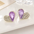 Macro shot of heart-shaped gold studs with purple teardrop crystals and pavé diamonds - Purple Style (A1479)