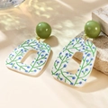 Detail of acrylic earring featuring blue berry print and green bead on stone background - White Marble Texture Foliage (A160)