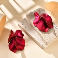 Elegant deep red petal earrings with matte finish on textured stone backdrop - Pearlescent Rose Red