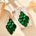 Detailed view of green layered leaf earrings with silk sheen on a stone pedestal - Pearlescent Green (A1593)