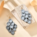 Detailed macro of matte blue layered petal tassel earrings on a textured stone base - Gray (A1604)