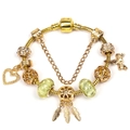 Golden snake chain bracelet with dreamcatcher charms and green glitter beads on white background - Golden Feather Bow Style (Style 006)