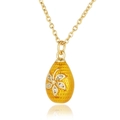 Detail of gold necklace featuring a yellow enamel egg pendant with a floral crystal inlay - Gold