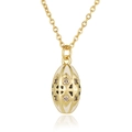 Macro detail of gold egg-shaped pendant with white enamel and sparkling crystals - White